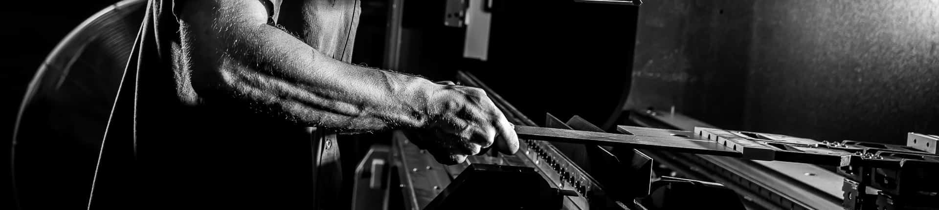 Man holding a piece of metal.